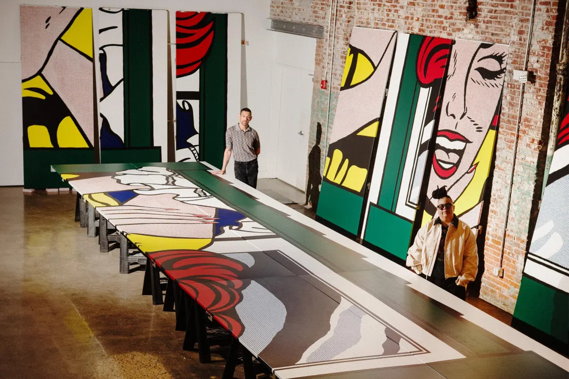 Artist Alex Da Corte, left, with curator Meg Onli, right, who are mounting the Whitney Museum of American Art’s exhibition, “Roy Lichtenstein: Like New,” stand with exhibit panels at a studio on Aug 17, 2026. The show, which opens Oct. 11, will bring together a vast swath of Lichtenstein’s work, whose last New York retrospective was some 33 years ago.