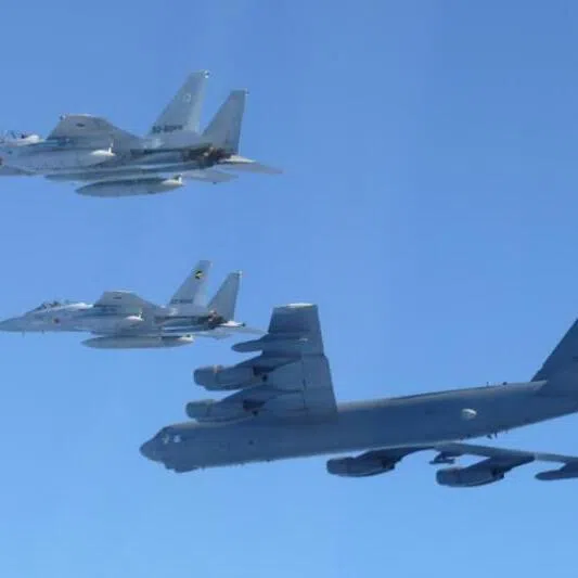 A US Air Force B-52 strategic bomber (bottom) and Japanese F-15 fighter jets during a joint exercise over the Sea of Japan on Dec 10, following joint patrols by Chinese and Russian aircraft.