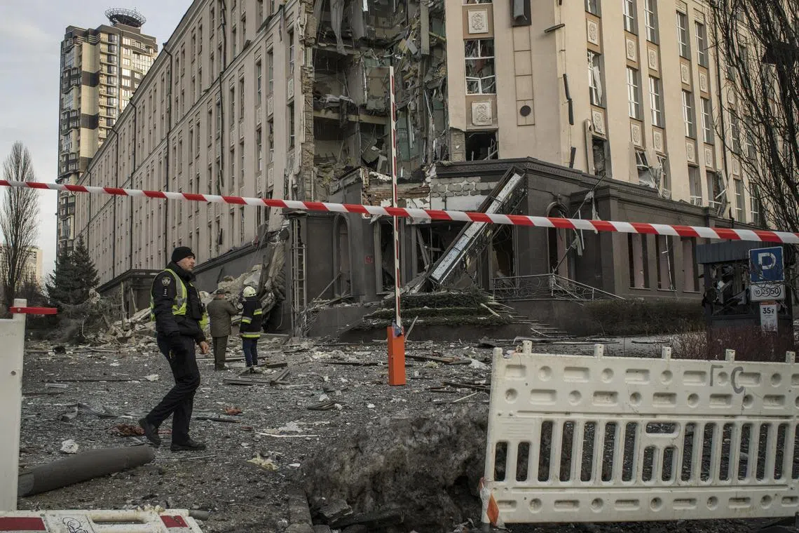 Law enforcement officials seal off the area around a hotel that was badly damaged by a Russian airstrike, in Kyiv, Ukraine on Saturday, Dec. 31, 2022. A fresh wave of Russian strikes hit Saturday as Ukrainians were preparing for New Year celebrations. Explosions rattled the capital, Kyiv, where at least one person was killed, and damage was reported in other cities. (Laura Boushnak/The New York Times)
