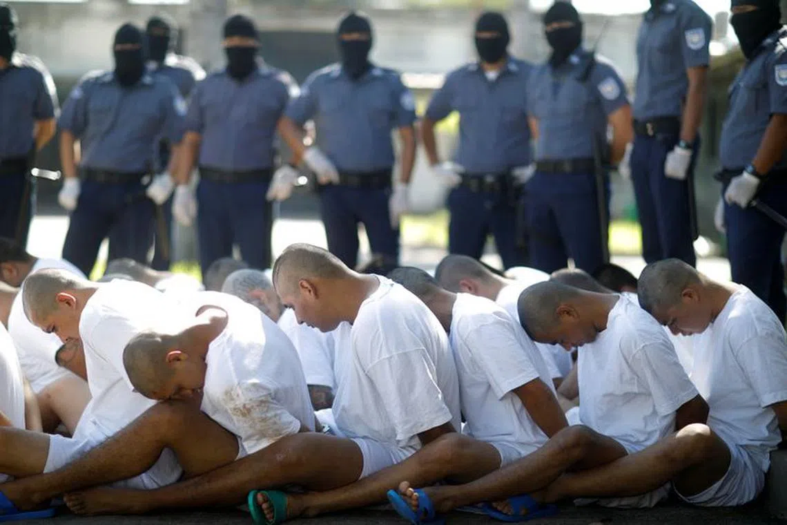 FILE PHOTO: Mara Salvatrucha (MS-13) gang members wait to be escorted upon arrival at the maximum-security jail in Zacatecoluca, El Salvador, January 31, 2019. REUTERS/Jose Cabezas/File Photo