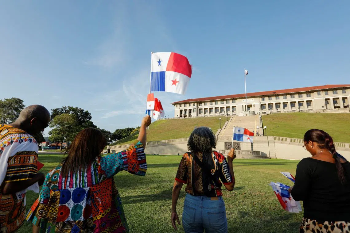 People hold Panama's national flags during a protest against U.S. President Donald Trump who intends to reclaim the Panama Canal, days before the arrival of U.S. Secretary of State Marco Rubio, in Panama City, Panama, January 30, 2025. REUTERS/Aris Martinez
