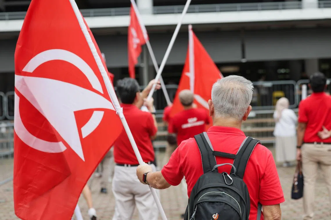 Singapore Democratic Party (SDP) supporters waving flags at Methodist Girls' School nomination centre, Apr 23, 2025.