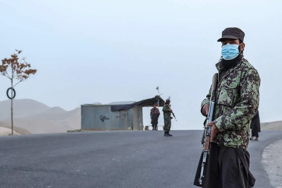 A Taliban security personnel stands guard at a checkpoint on the outskirts of Qala-i-Naw in the Badghis province in October.  A man convicted of murder was publicly executed on Dec 2 in eastern Afghanistan.