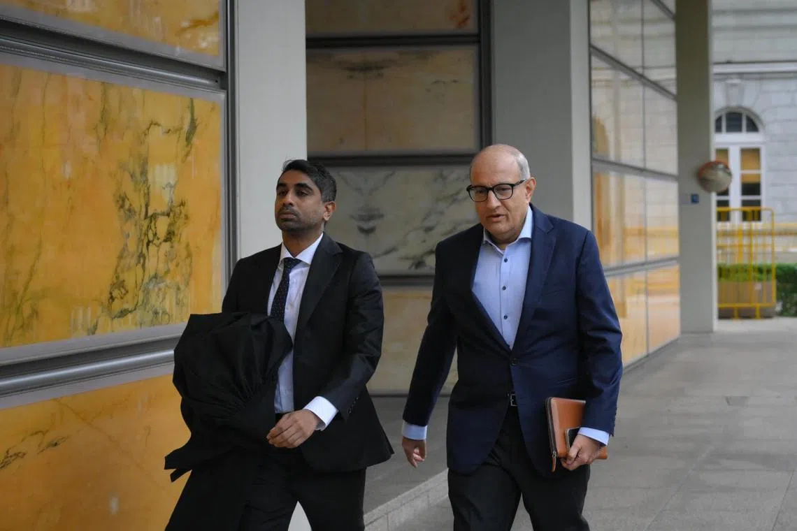 Former transport minister S. Iswaran arriving at the Supreme Court with his lawyer on July 5.
