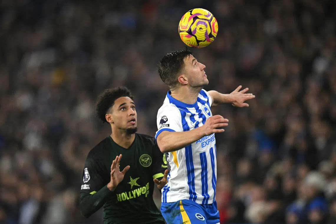Brighton & Hove Albion's Joel Veltman in action with Brentford's Kevin Schade.