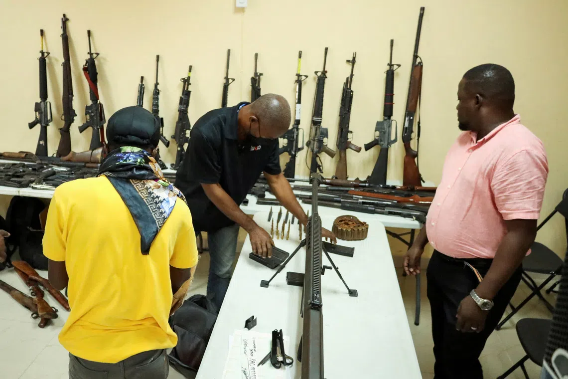 Weapons and ammunition seized during different operations against gangs are presented during a press conference, in Port-au-Prince, Haiti, November 28, 2025. REUTERS/Fildor Pq Egeder