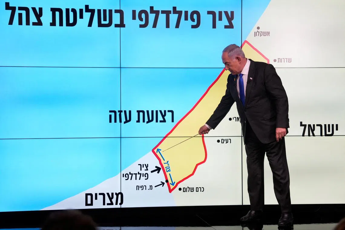 Israeli Prime Minister Benjamin Netanyahu stands before a map of the Gaza Strip, telling viewers that Israel must retain control over the \"Philadelphi corridor,\" a strategic area along the territory's border with Egypt, during a news conference in Jerusalem, September 2, 2024.  Ohad Zwigenberg/Pool via REUTERS