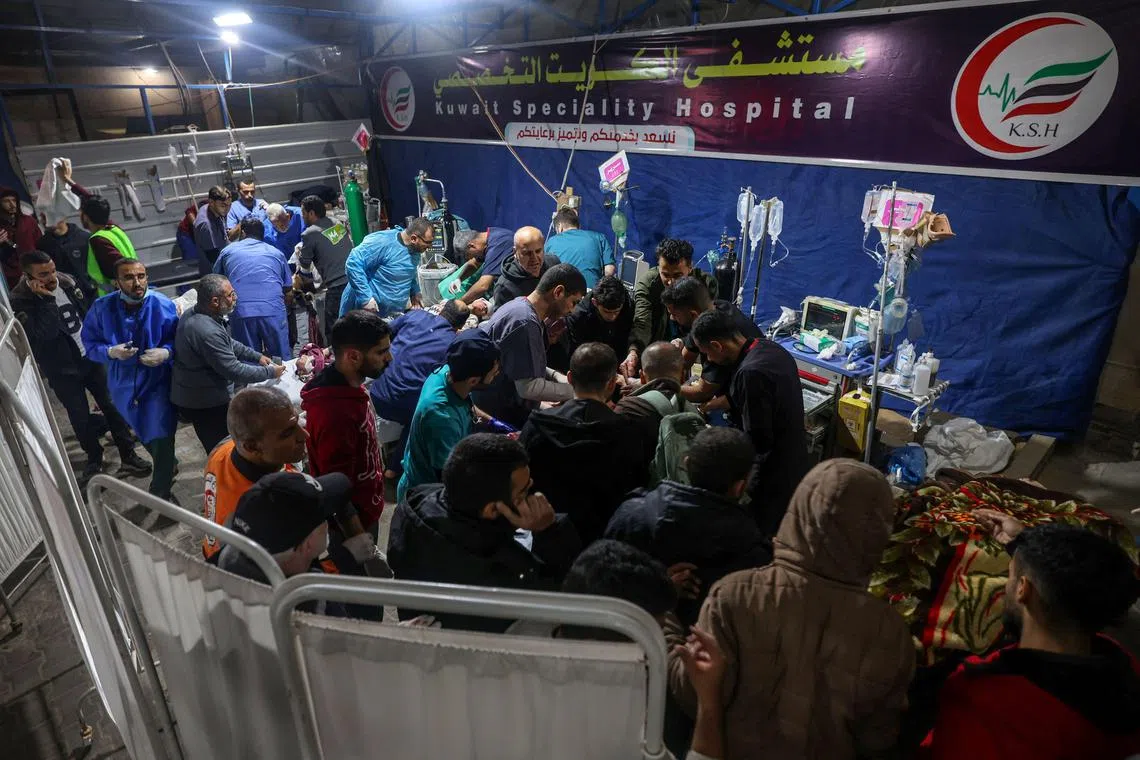 Victims of an Israeli strike in Rafah, in the southern Gaza Strip, are are helped by medical staff at Kuwait hospital