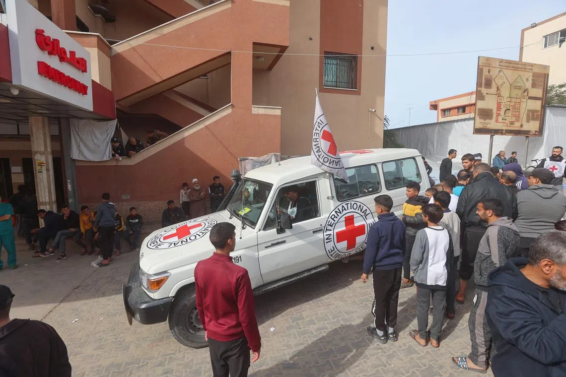 Workers and staff unload medical aid delivered to Nasser hospital in the Gaza Strip by the Red Cross on December 9.