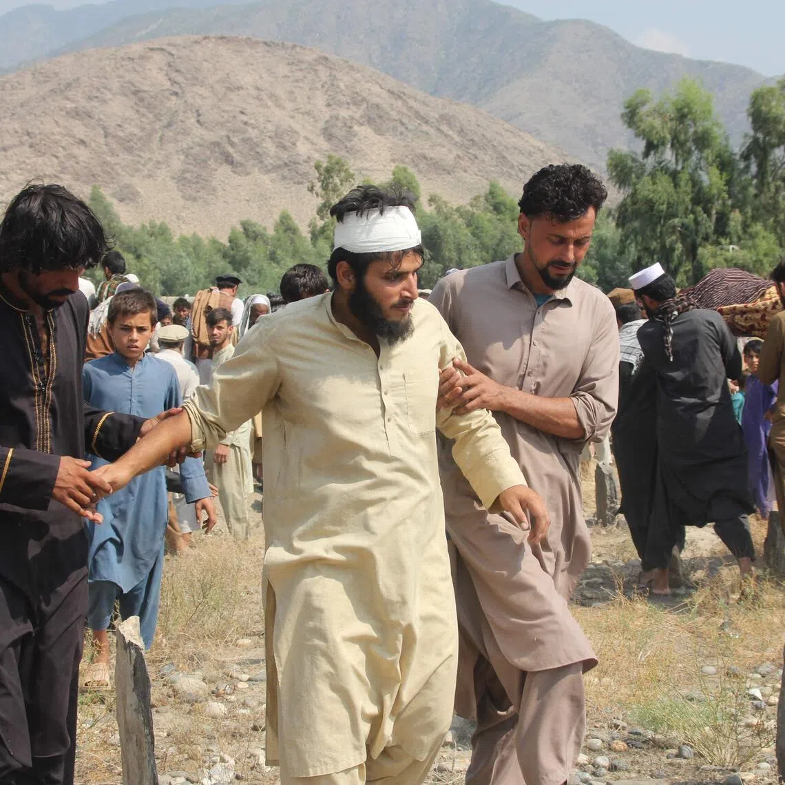 A man is rescued in the aftermath of a Pakistani air strike in the Nurgal district of Afghanistan’s Kunar province on Sept 21.