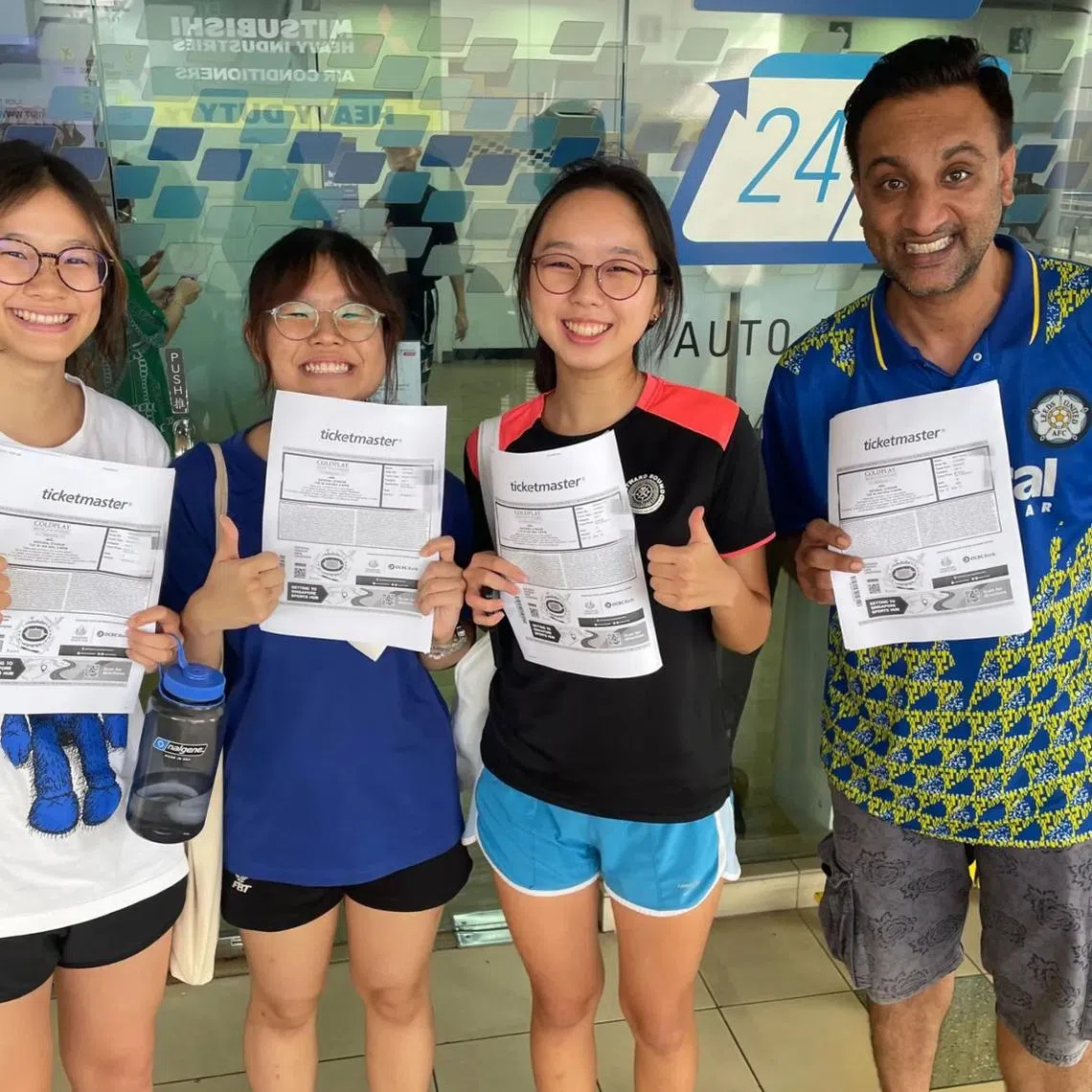 (From left) Ms Adrienne Chue, 19, Ms Jamie Ang, 19, Ms Elsa Tan, 19, and Mr Alex Gazza, 35 at Toa Payoh SingPost after obtaining Coldplay tickets.