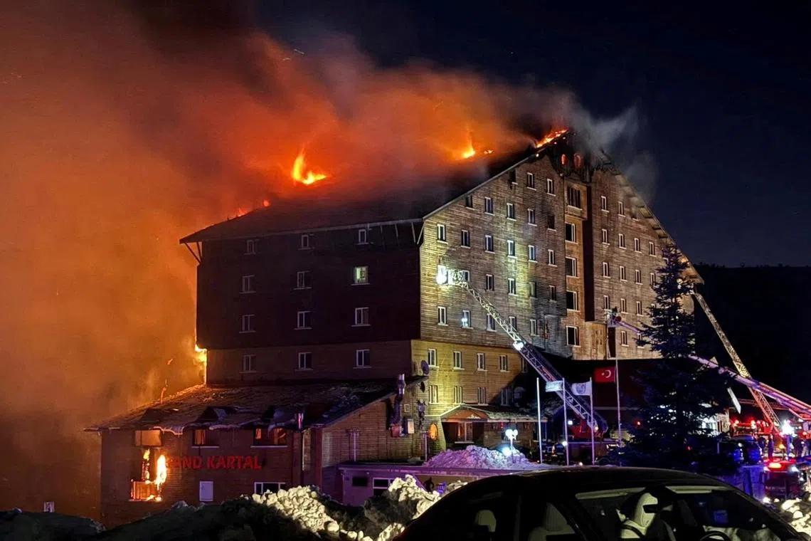 Firefighters work to extinguish a fire at a hotel in the ski resort of Kartalkaya in Bolu, Turkey, January 21, 2025. Ihlas News Agency (IHA) via REUTERS