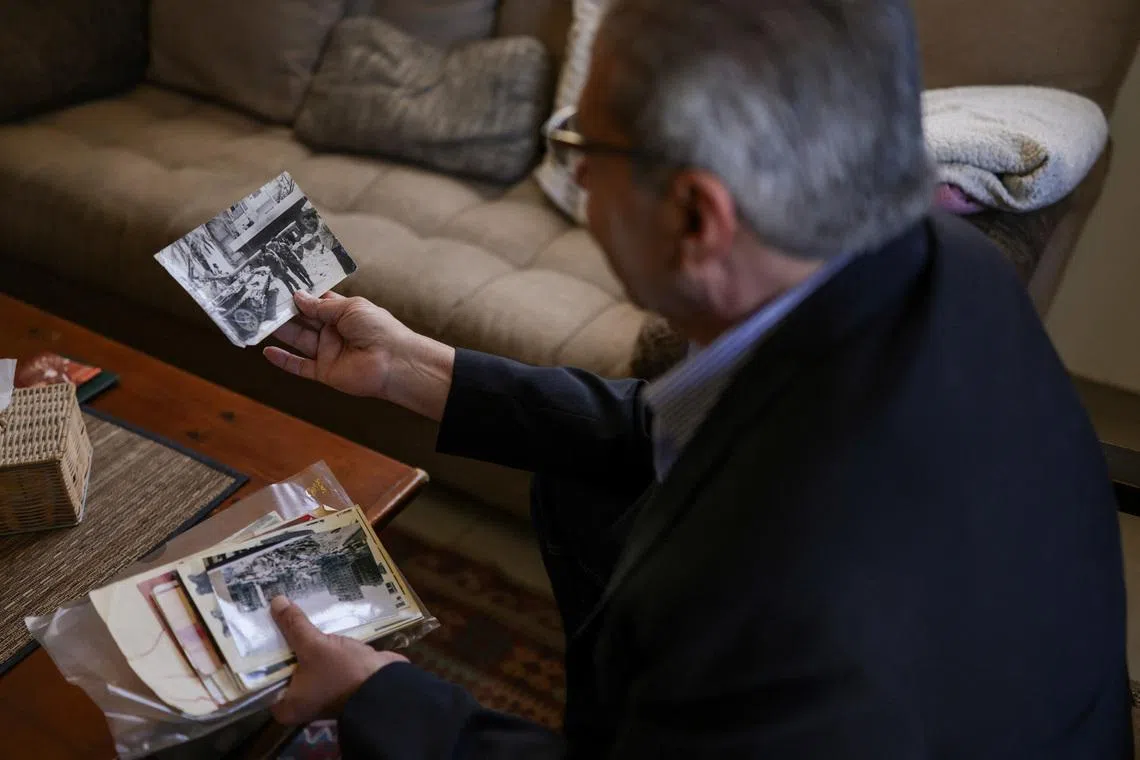 Head of the Lebanese NGO Fighters for Peace Ziad Saab looks at a picture of himself during the Lebanese civil war, in his home in Beirut on April 14.