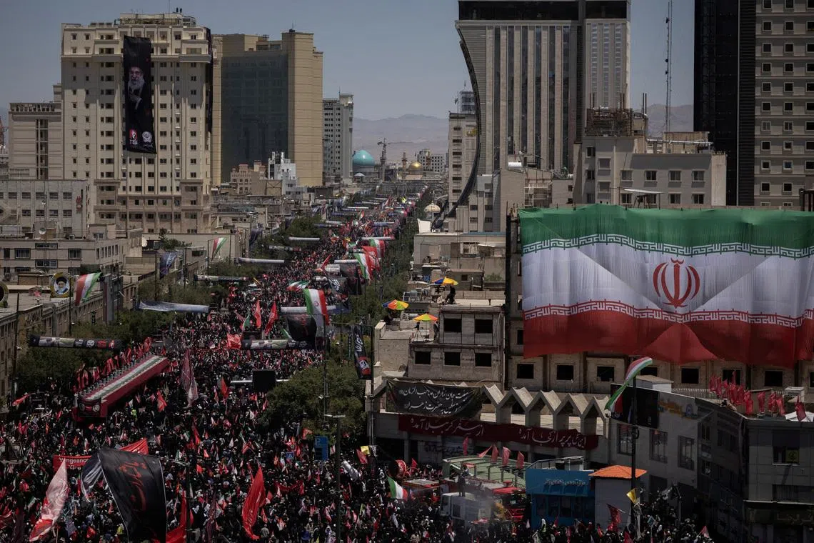 Mourners attend a funeral procession on the day of the burial of Iran’s late Supreme Leader Ayatollah Ali Khamenei in Mashhad, Iran, on July 9.