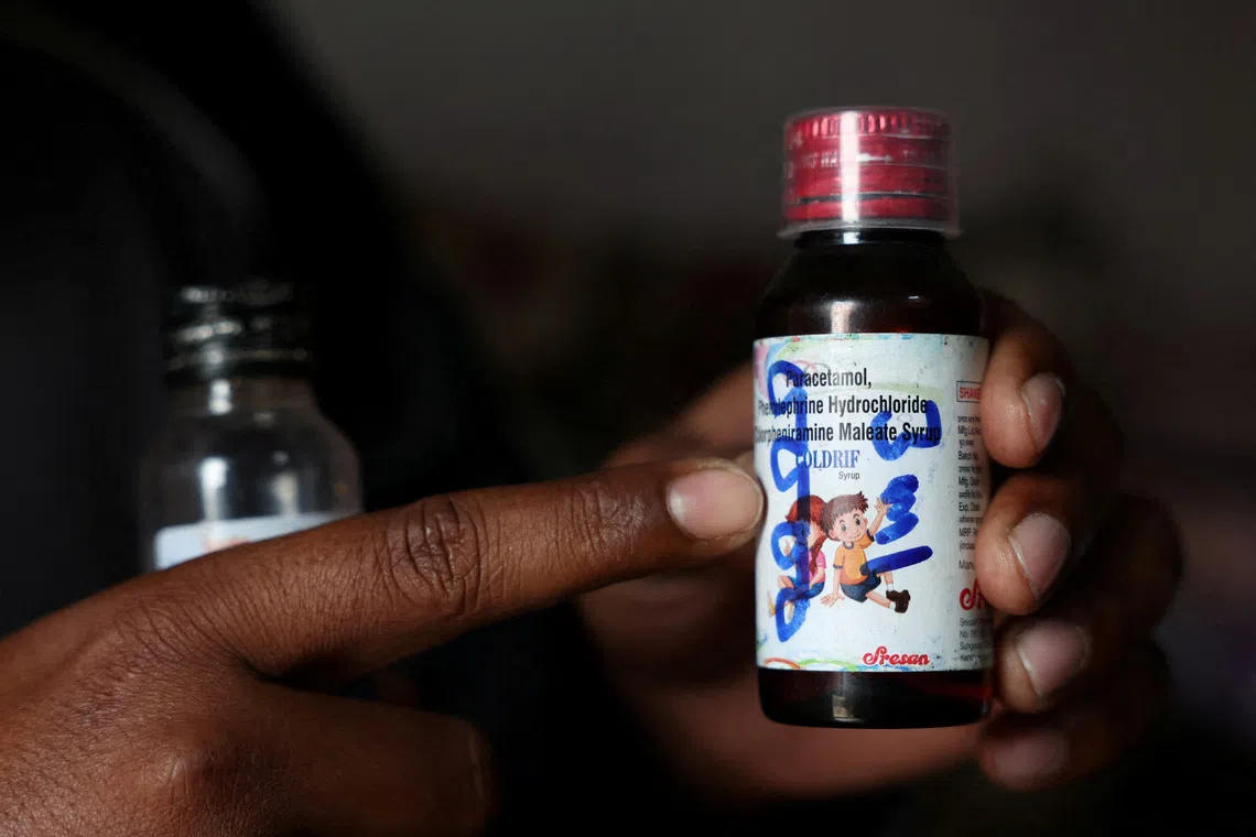 FILE PHOTO: Saddam Mansuri shows a bottle of Coldrif cough syrup, which has been linked to the deaths of multiple children and which he had been giving to his one-year-old child, in Parasia, Madhya Pradesh, India, October 10, 2025. REUTERS/Priyanshu Singh/File Photo