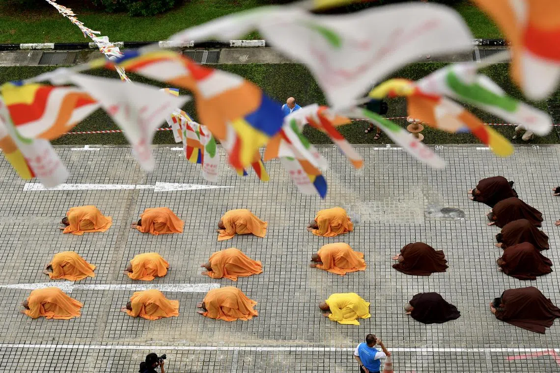 Buddhist monks performing the "three steps, one bow" ritual at the Kong Meng San Phor Kark See Monastery in Bright Hill Road on June 1, ahead of Vesak Day on June 2, 2023.