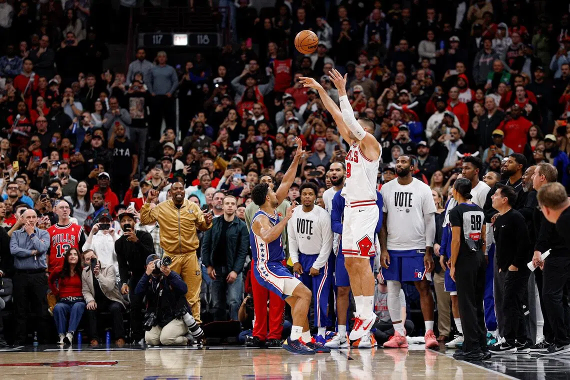 Chicago Bulls centre Nikola Vucevic shooting and scoring a game-winning three-pointer against Philadelphia 76ers guard Quentin Grimes during the second half of their 113-111 NBA home win at United Centre on Nov 4, 2025.