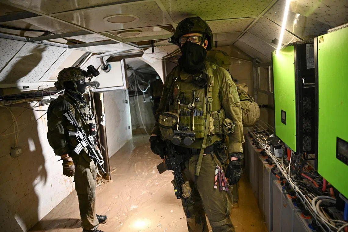 Israeli soldiers operate in what the military described as a Hamas command tunnel, running partly under UNRWA Headquarters in the Gaza Strip.