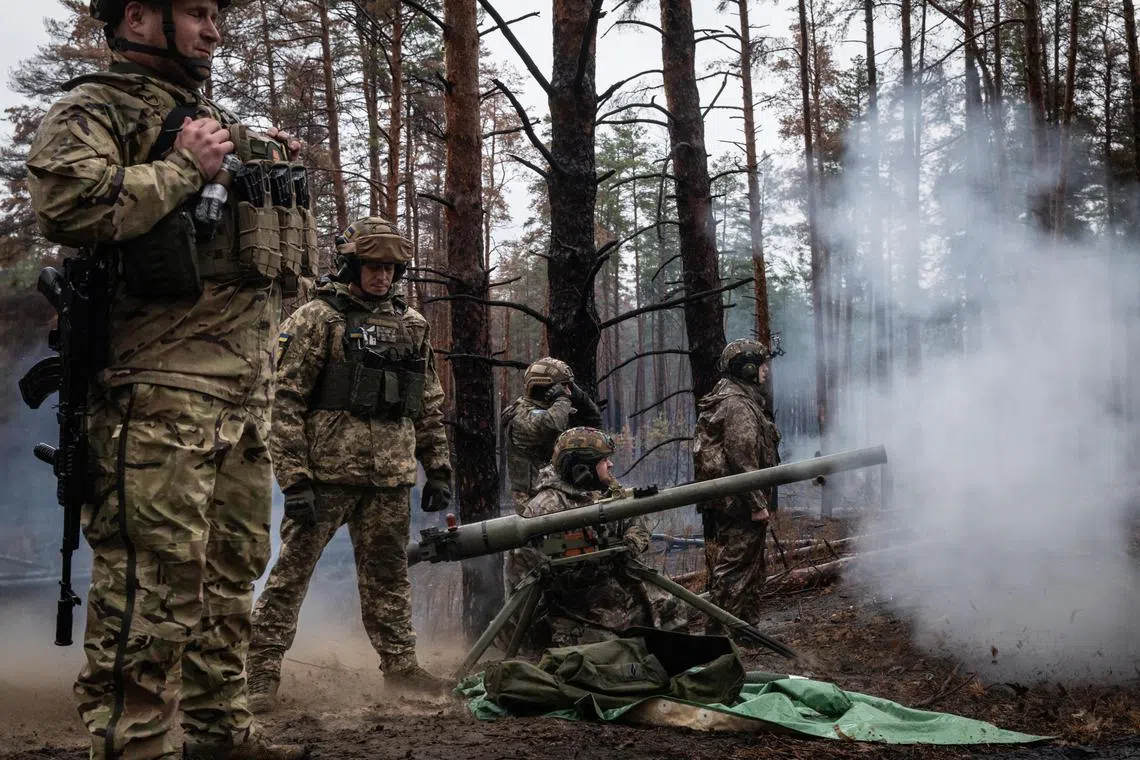 Soldiers fired a grenade launcher toward Russian forces near the Kreminna front line in the Donetsk region of Ukraine on Oct 28. 