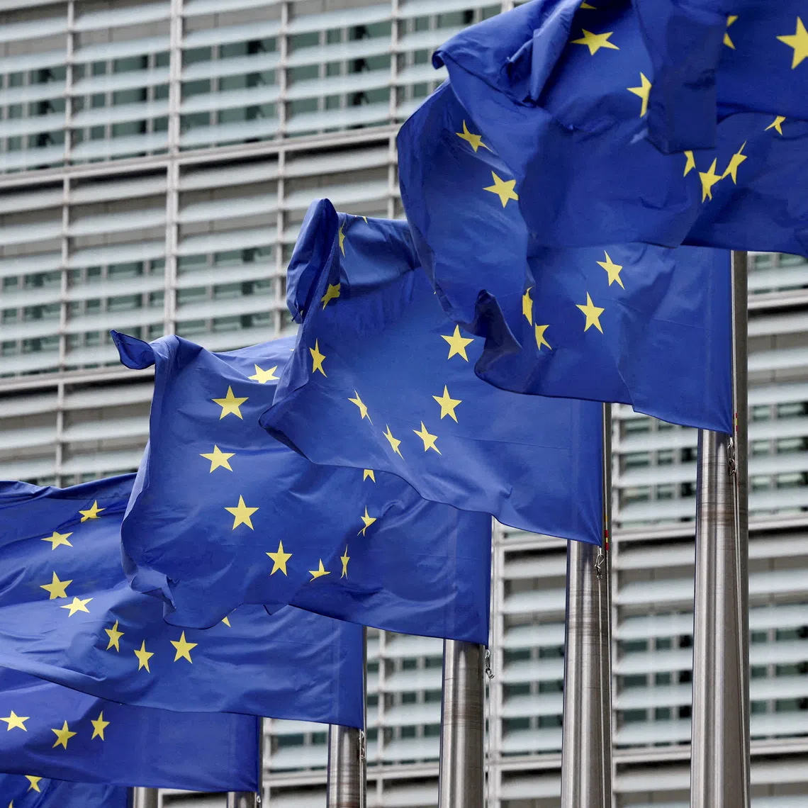 FILE PHOTO: European Union flags flutter outside the EU Commission headquarters in Brussels, Belgium July 16, 2025. REUTERS/Yves Herman//File Photo