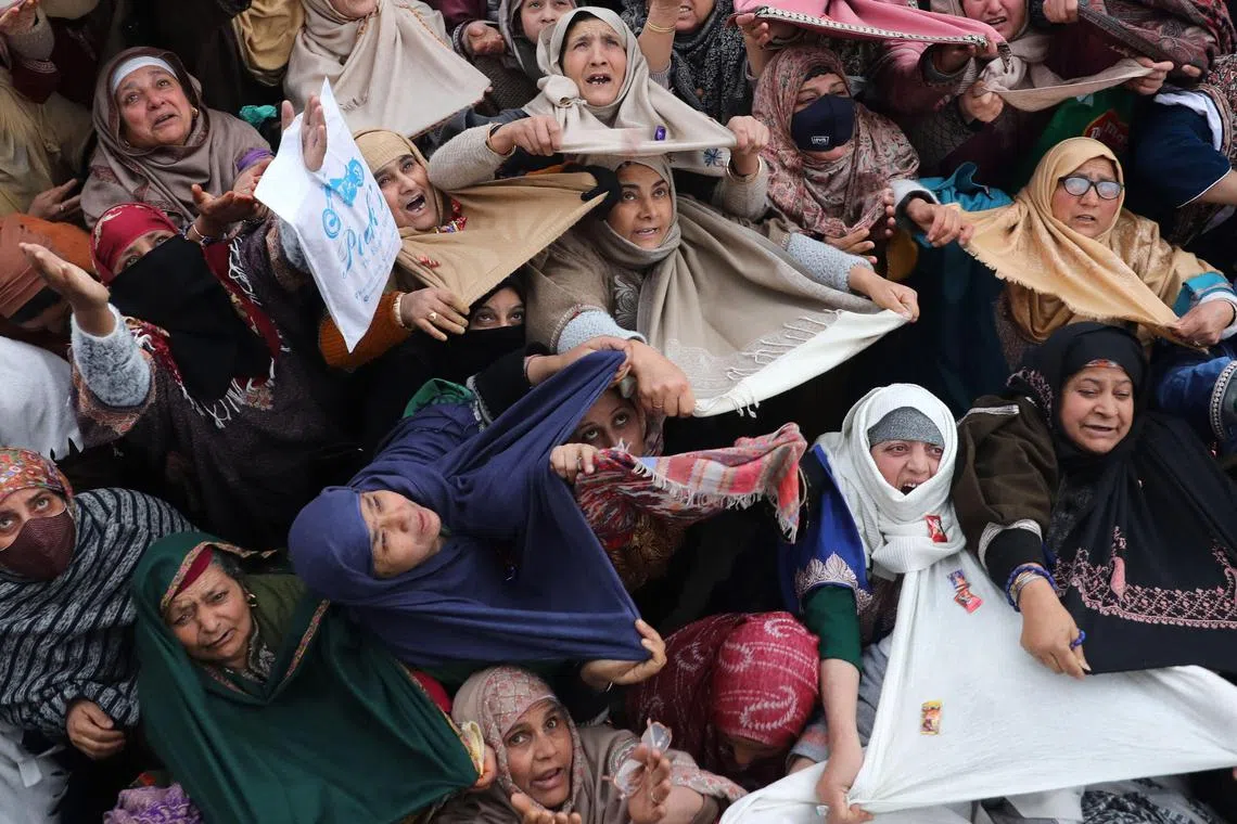 Kashmiri Muslims pray as they look at a holy relic believed to contain hair from the beard of the Prophet Muhammad on the occasion of Meraj-u-Alam at the famous Hazratbal shrine,  in Srinagar, the summer capital of Indian Kashmir, India, Feb 19, 2023. Hundreds of Muslims flocked to the shrine on the occasion of Mehraj-u-Alam, ascension of the prophet Muhammad to Heaven.  