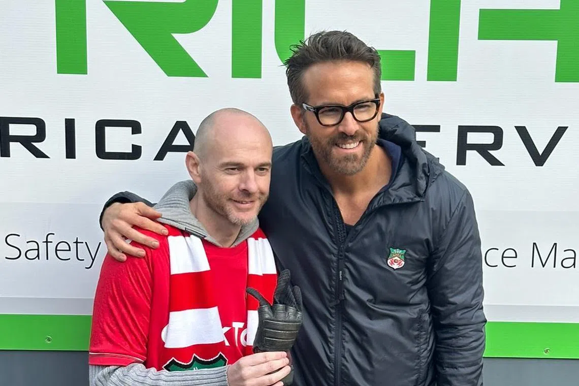 Actor Ryan Reynolds (right) with Wrexham fan Jay Fear, who has terminal cancer.