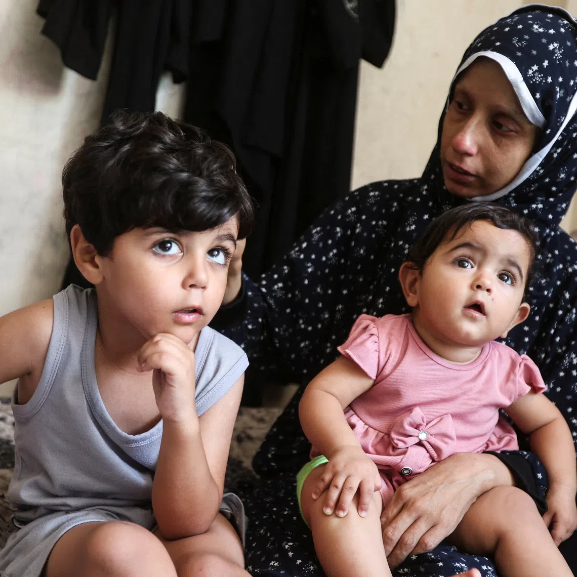 Displaced Palestinian cancer patient Khuloud Abu Sahmoud, 33, sitting with her children in an UNRWA school where she is sheltering in the southern Gaza Strip, on Aug 8.