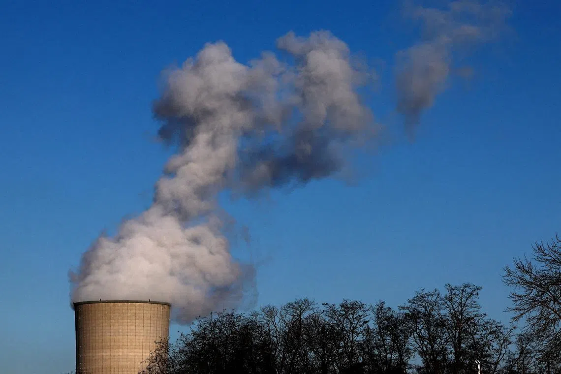 FILE PHOTO: Smoke billows from a chimney at a combined-cycle gas turbine power plant in Drogenbos, Belgium January 16, 2024. REUTERS/Yves Herman/File Photo