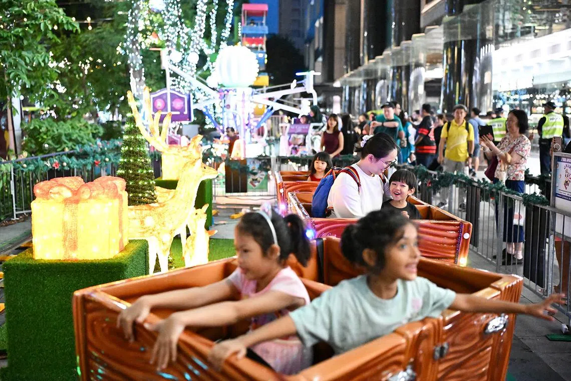 ST20241224_202430800741-Lim Yaohui-pixchristmas24/ People enjoying themselves on the Texas Train carnival ride at Shaw House Urban Plaza which is part of The Great Christmas Village at Orchard Road on Dec 24, 2024. The much-anticipated Great Christmas Eve Street Party is making a triumphant return, stretching 400m from ION Orchard to Ngee Ann City. It will feature live DJ performances, roving mascots, pop-up stalls, food trucks, as well as a countdown to Christmas, among other offerings. A section of Orchard Road from Paterson Road junction to Bideford Road junction will be closed to vehicular traffic on 24 December 2024 from 6pm to 2am for revellers as the countdown to Christmas Day begins at 8pm. (ST PHOTO: LIM YAOHUI)