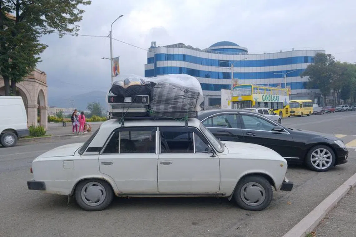 FILE PHOTO: A view shows a car loaded with belongings of people leaving Nagorno-Karabakh, a region inhabited by ethnic Armenians, on a street in Stepanakert, September 25, 2023. REUTERS/Hasmik Khachatryan/File Photo
