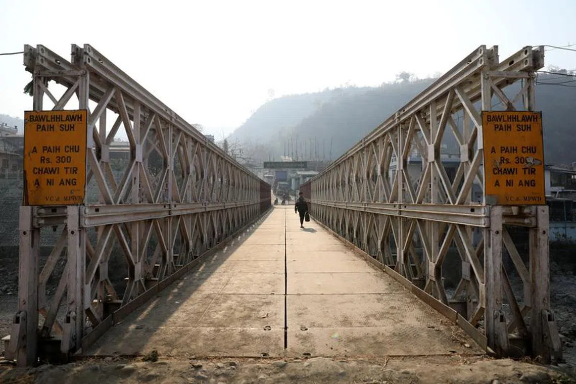 FILE PHOTO: A person walks on a bridge that connects Myanmar and India at the border village of Zokhawthar,  Champhai district, in India's northeastern state of Mizoram, India, March 12, 2021. REUTERS/Rupak De Chowdhuri
