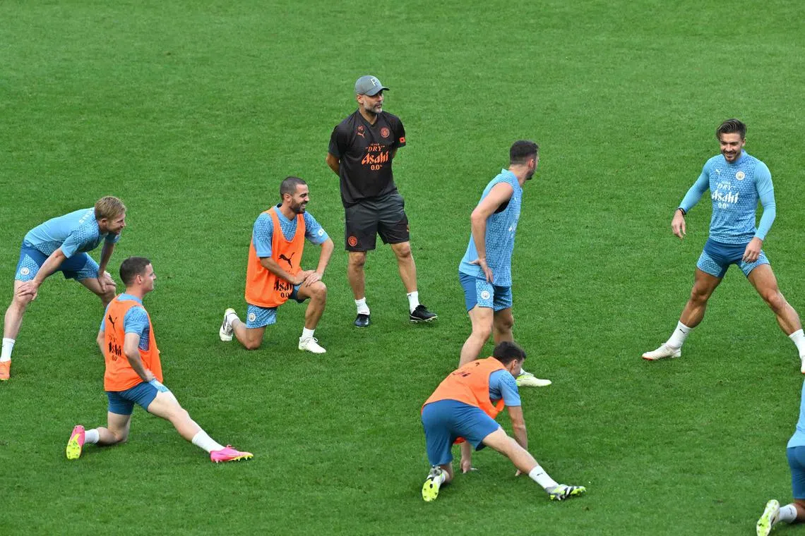 Manchester City manager Pep Guardiola watching his team train at the Seoul World Cup Stadium.