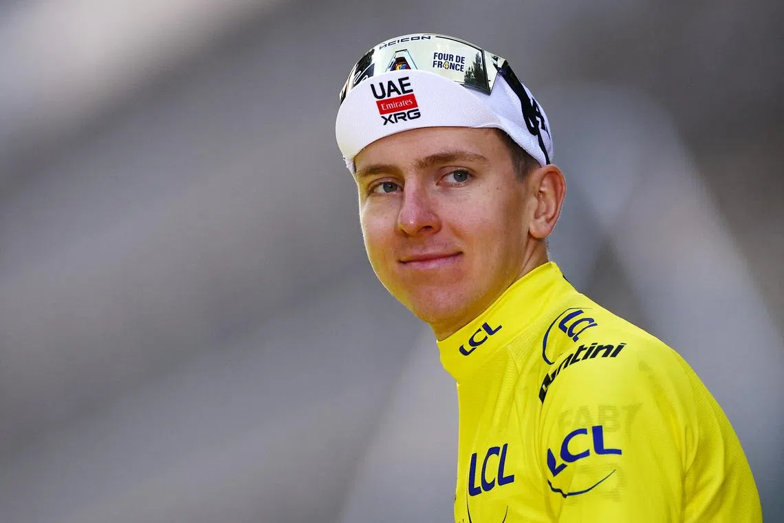 Cycling - Tour de France - Stage 21 - Mantes-la-Ville to Paris - Paris, France - July 27, 2025 UAE Team Emirates XRG's Tadej Pogacar walks onto the podium while wearing the yellow jersey after winning the Tour de France REUTERS/Sarah Meyssonnier