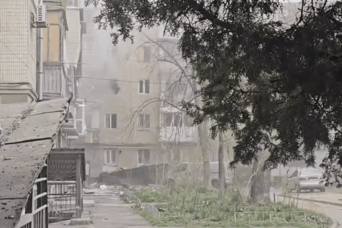 A screenshot from a video showing an attack on apartment blocks in the Ukrainian city of Kherson on March 27.