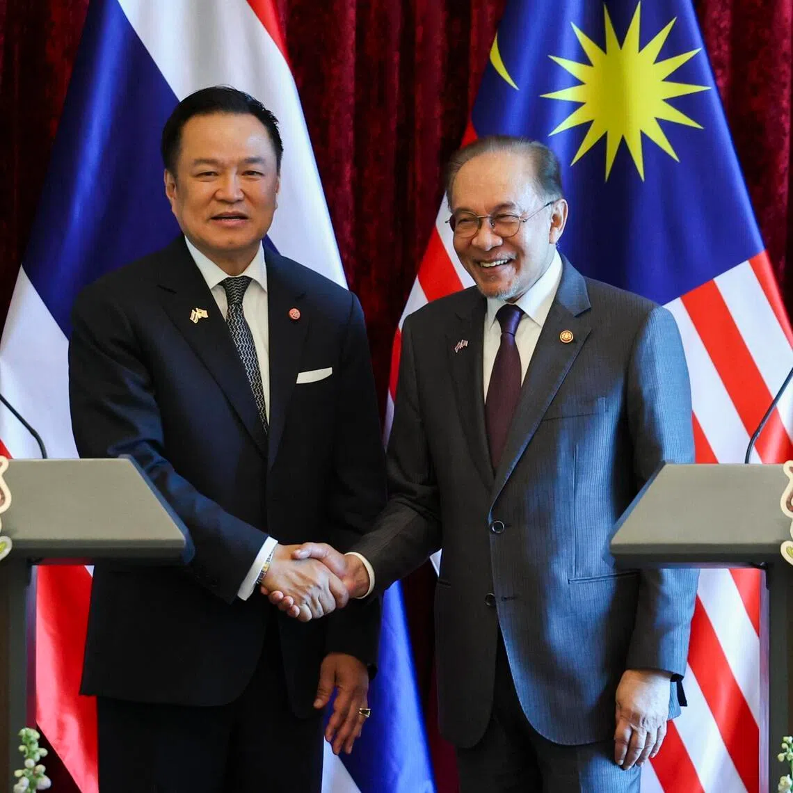 Thailand’s Prime Minister Anutin Charnvirakul (left) shakes hands Malaysia’s Prime Minister Anwar Ibrahim after a press conference at the Federal Government office of Perdana Putra in Putrajaya.