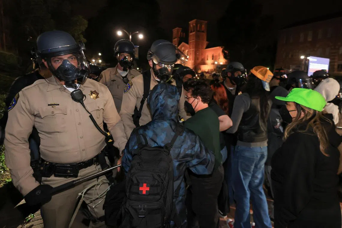 Pro-Palestinian protesters face off with police officers inside the University of California, Los Angeles campus.