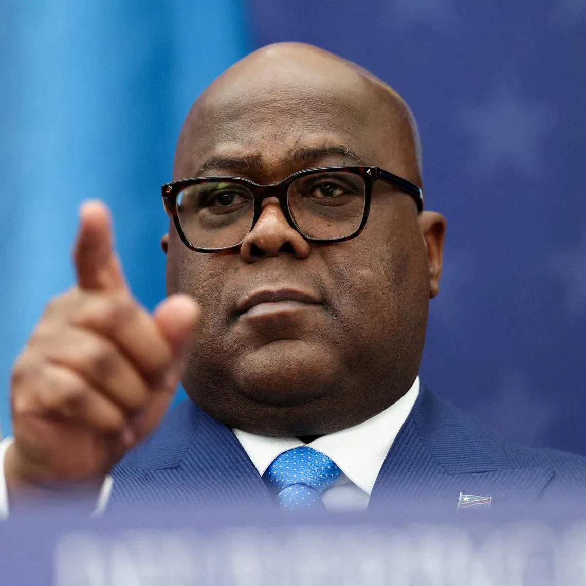 FILE PHOTO: President of the Democratic Republic of the Congo Felix Tshisekedi gestures during a signing ceremony next to U.S. President Donald Trump and President of Rwanda Paul Kagame (not pictured) at the U.S. Institute of Peace in Washington, D.C., U.S., December 4, 2025. REUTERS/Kevin Lamarque/File Photo