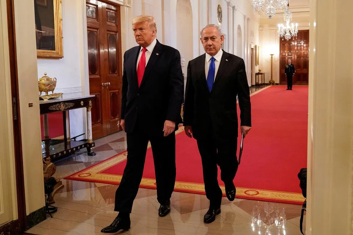 FILE PHOTO: U.S. President Donald Trump and Israel's Prime Minister Benjamin Netanyahu arrive to deliver joint remarks on a Middle East peace plan proposal in the East Room of the White House in Washington, U.S., January 28, 2020. REUTERS/Joshua Roberts/File Photo