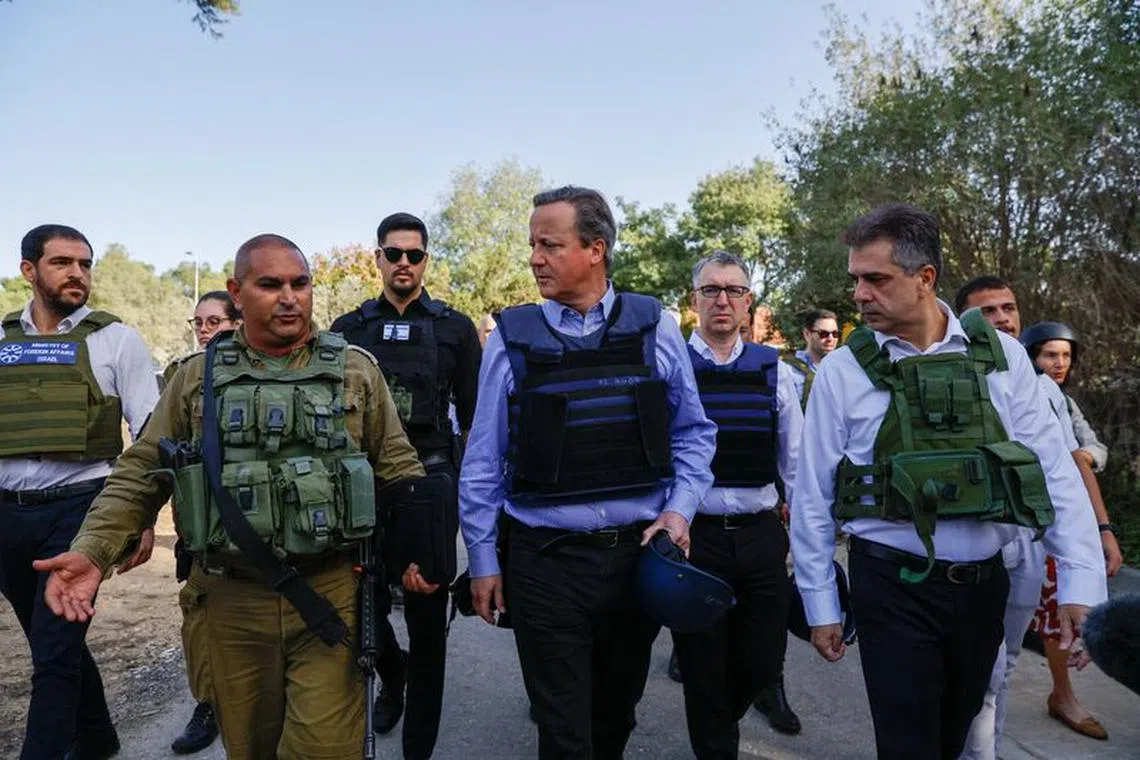 British Foreign Secretary David Cameron and Israeli Foreign Minister Eli Cohen visit Kibbutz Beeri following the October 7 deadly attack by the Palestinian Islamist group Hamas, in southern Israel, November 23, 2023. REUTERS/Alexander Ermochenko