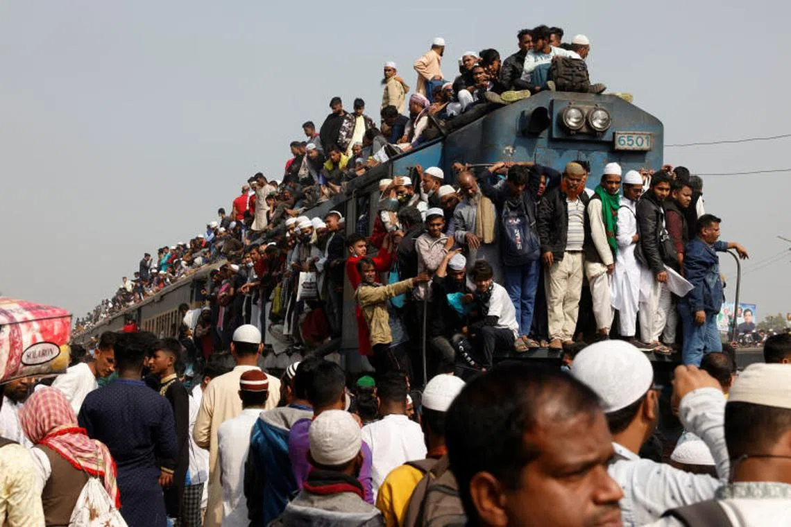 Devotees climb on the rooftop of an overcrowded train to return home, after attending the final prayer of Bishwa Ijtema, which is considered the worldÕs second-largest Muslim gathering after Haj, in Tongi, outskirts of Dhaka, Bangladesh on January 15, 2023. PHOTO : REUTERS