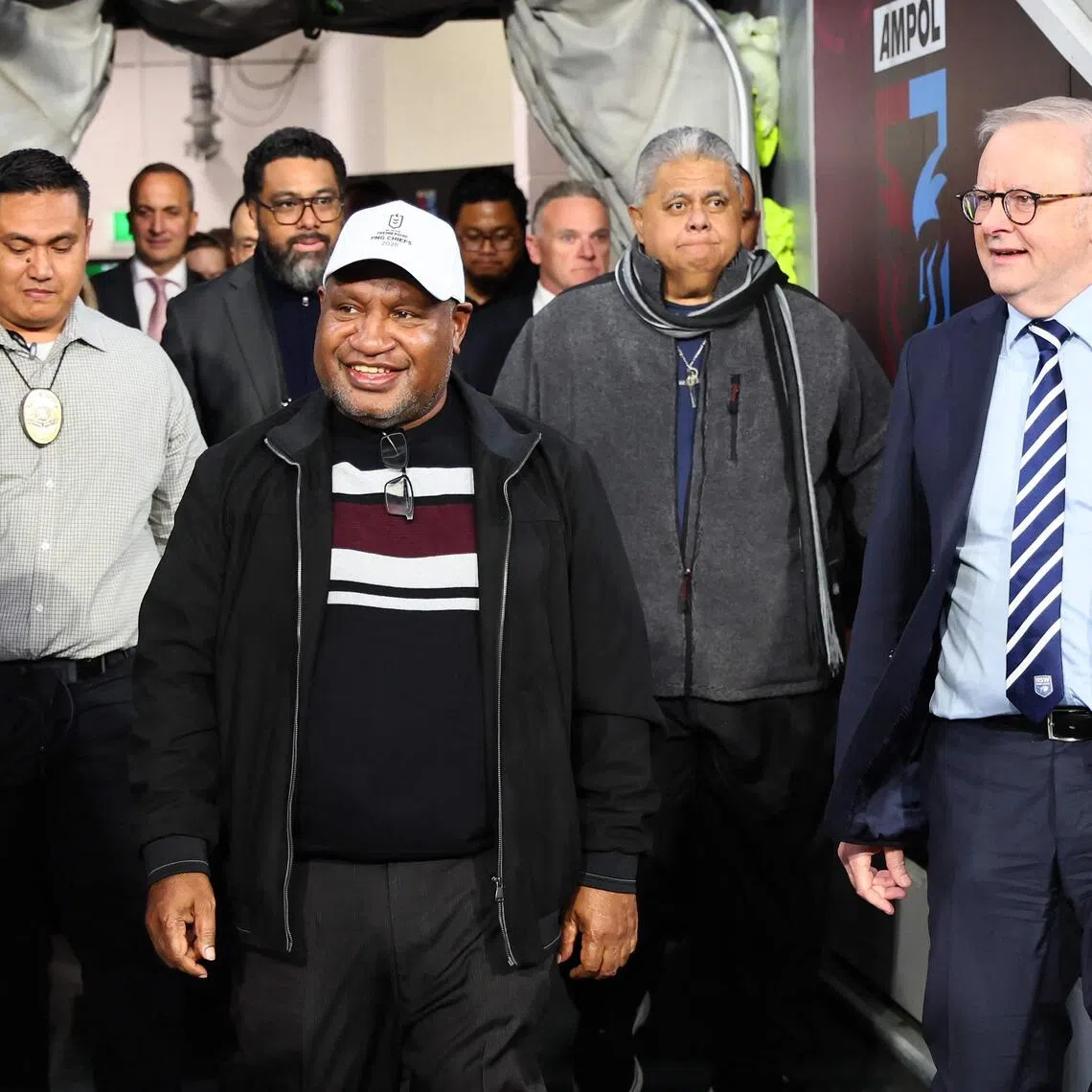 Australian Prime Minister Anthony Albanese (R) escorts Samoa's Prime Minister La?auli Leuatea Schmidt (C) and Papua New Guinea's Prime Minister James Marape (L) onto the field prior to Game Three of the men's State of Origin rugby league series between the New South Wales Blues and the Queensland Maroons in Brisbane on July 8, 2026. (Photo by TERTIUS PICKARD / AFP) / -- IMAGE RESTRICTED TO EDITORIAL USE - STRICTLY NO COMMERCIAL USE --