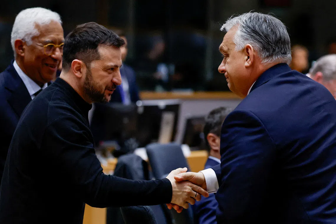 FILE PHOTO: Ukrainian President Volodymyr Zelenskiy shakes hands with Hungarian Prime Minister Viktor Orban at a European Union leaders' special summit to discuss Ukraine and European defence, in Brussels, Belgium March 6, 2025. REUTERS/Christian Hartmann     TPX IMAGES OF THE DAY/File Photo