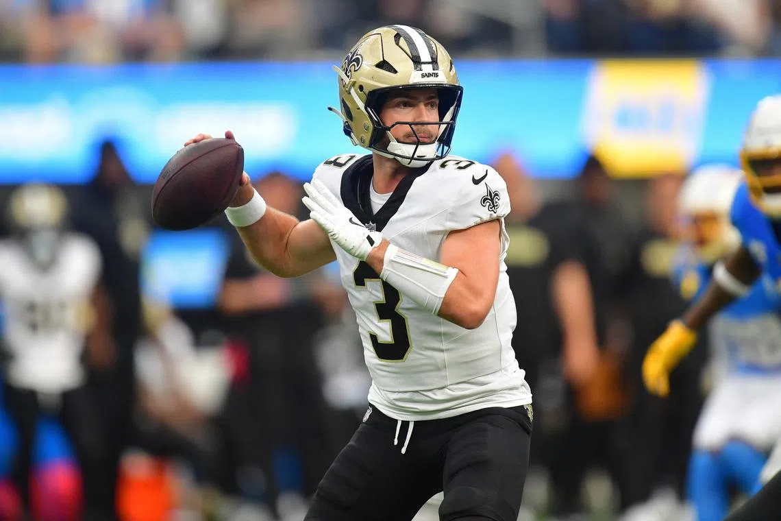 FILE PHOTO: Oct 27, 2024; Inglewood, California, USA; New Orleans Saints quarterback Jake Haener (3) throws against the Los Angeles Chargers during the second half at SoFi Stadium. Mandatory Credit: Gary A. Vasquez-Imagn Images/File Photo