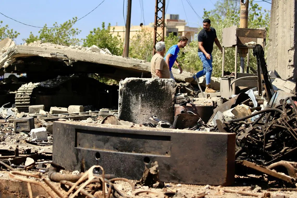 People inspecting the site of an Israeli air strike in southern Lebanon on Aug 7.