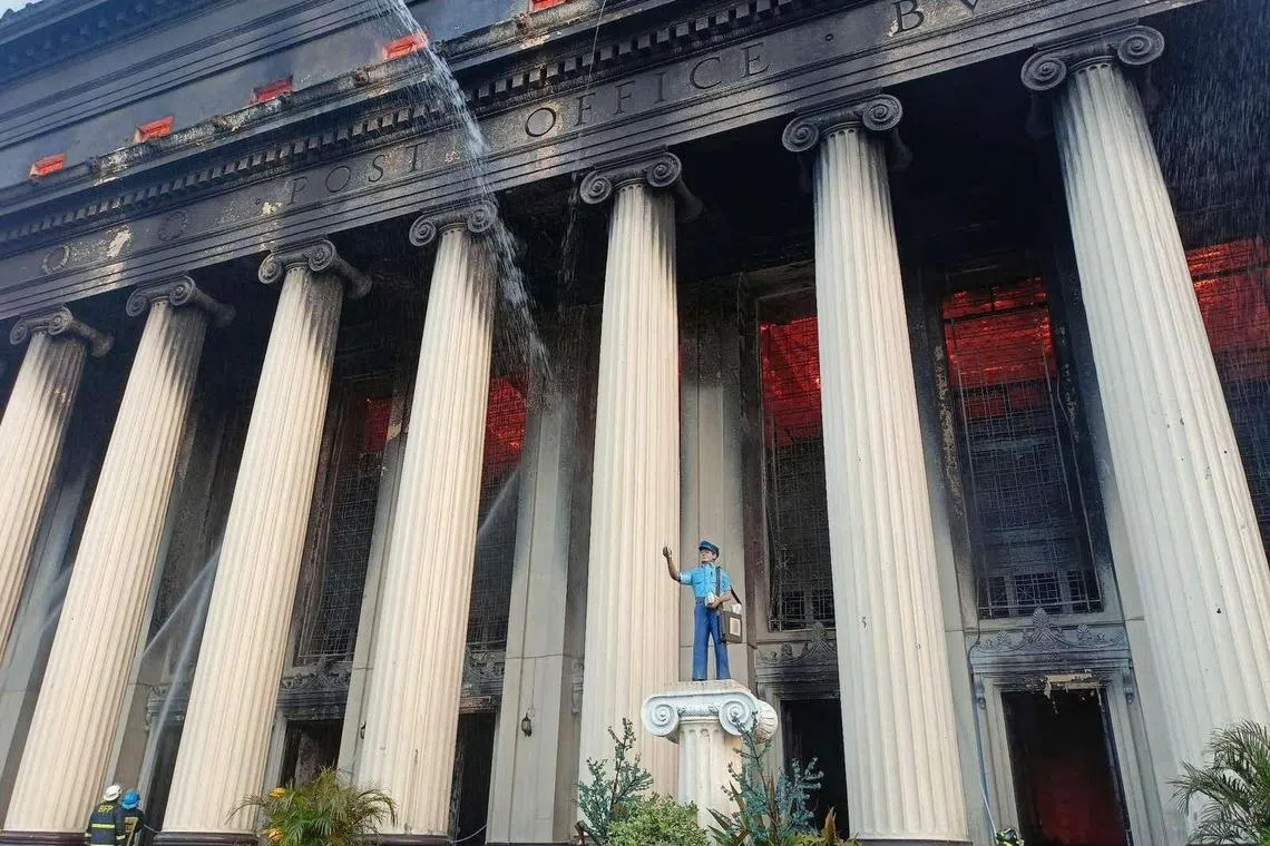 Firefighters spray water as a massive fire breaks out at the  Manila Central Post Office building in Manila, Philippines, May 22, 2023. 