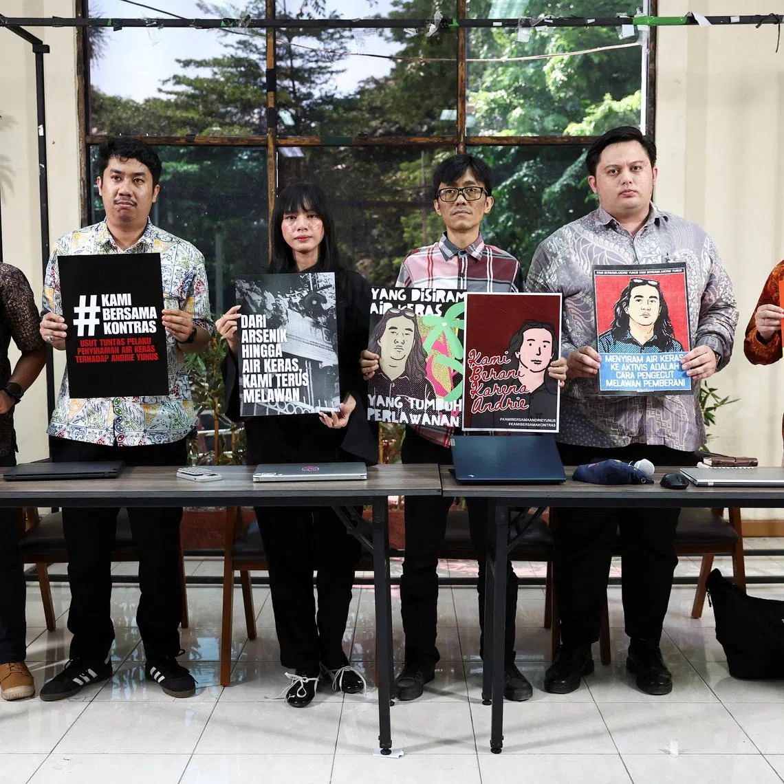 Advocacy for Democracy Team (TAUD) members hold posters in solidarity with Andrie Yunus, an activist and deputy coordinator with Indonesia's rights group Commission for Missing Persons and Victims of Violence (KontraS), who suffered burns to 24% of his face and arms from acid thrown by two unidentified assailants on a motorcycle on March 12, after a press conference in Jakarta, Indonesia, March 16, 2026. REUTERS/Willy Kurniawan