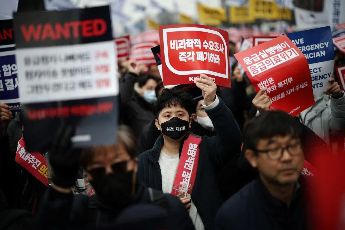 Doctors chant slogans during a rally to protest against government plans to increase medical school admissions in Seoul, South Korea, March 3, 2024.   REUTERS/Kim Hong-Ji