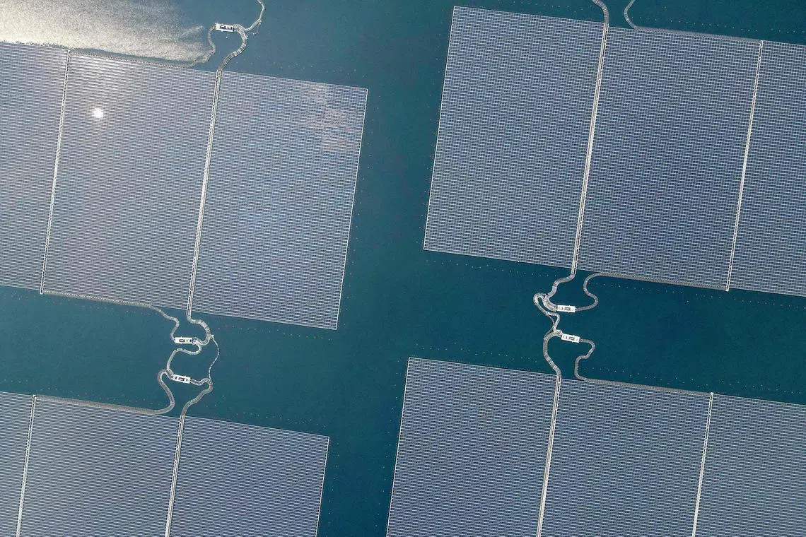 This aerial picture shows the newly built floating solar power plant on the water that can generate 192 mega watts of peak electricity in cooperation between the Indonesian government and Masdar from the UAE, at Cirata Reservoir, West Java, on November 9, 2023, shortly before being inaugurated by President Joko Widodo. (Photo by BAY ISMOYO / AFP)
