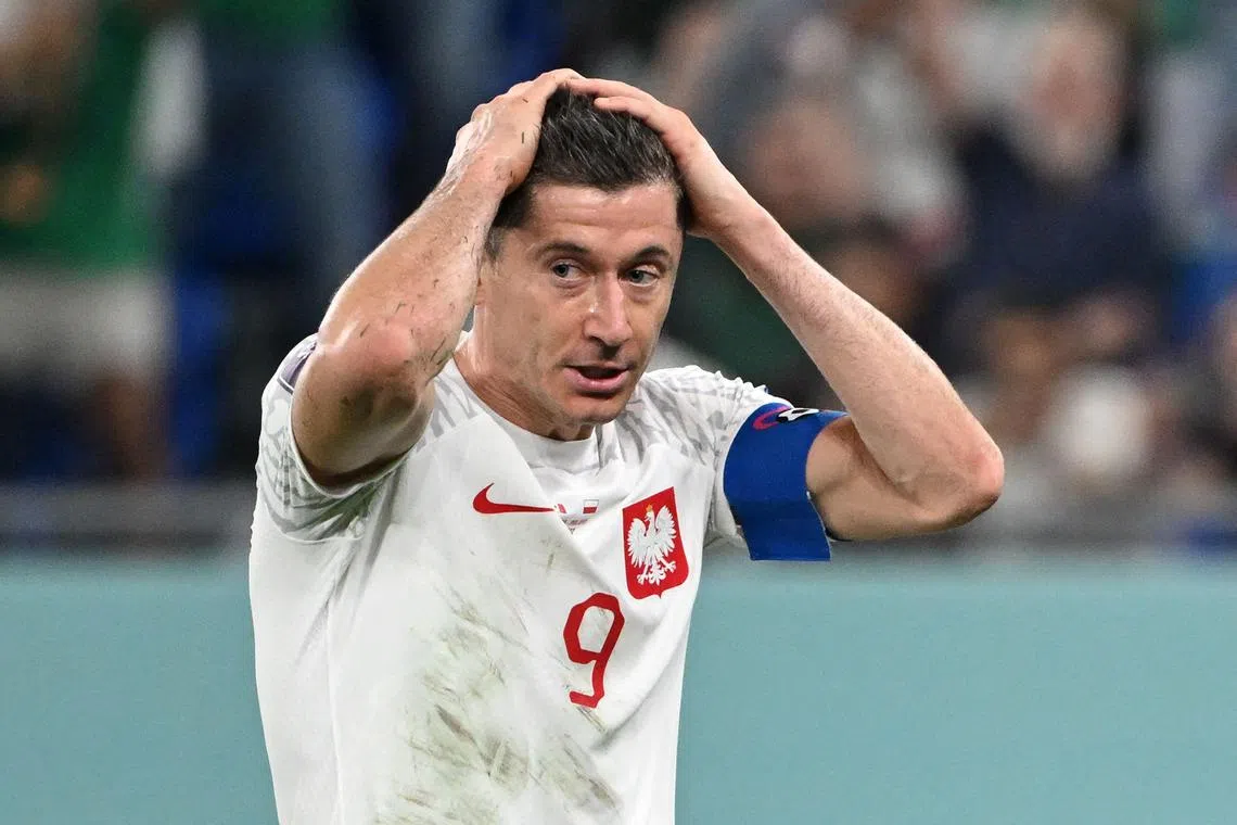 Poland forward Robert Lewandowski reacts after missing a penalty against Mexico.