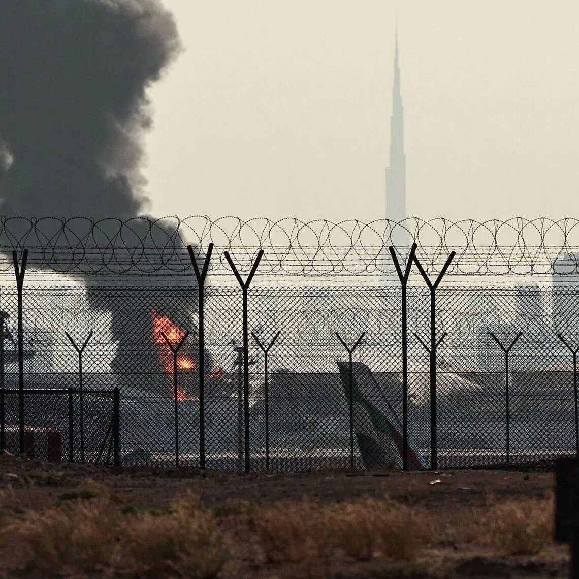 A smoke plume rises from an ongoing fire near Dubai International Airport on March 16.